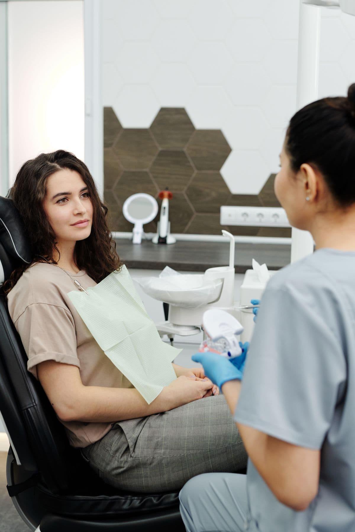 Dentist walking a patient through a treatment plan with a dental model